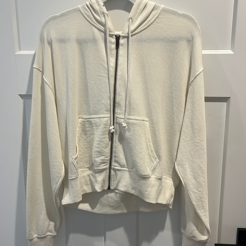 A cream\white colored zip up hoodie, from True Craft, woman’s small.